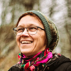laughing smiling in beanie and glasses